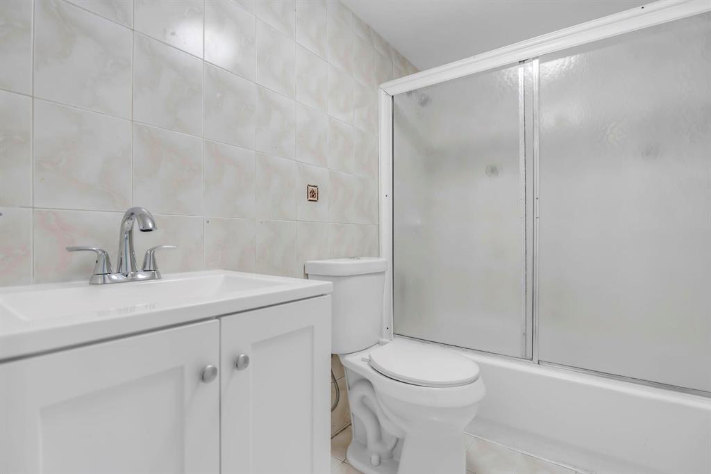 4801 Northwest 7th Street, Unit 50316 Miami, FL 33126 - Photo 17 of 31 a bathroom with a sink a toilet and shower