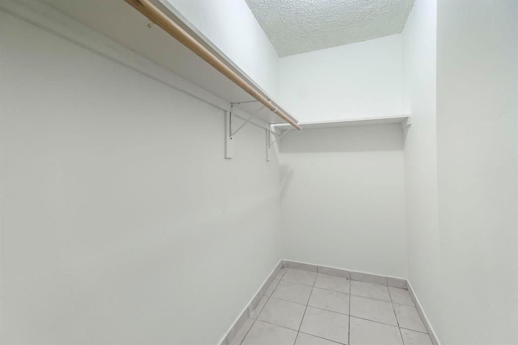 4801 Northwest 7th Street, Unit 50316 Miami, FL 33126 - Photo 18 of 31 a view of an empty walk in closet