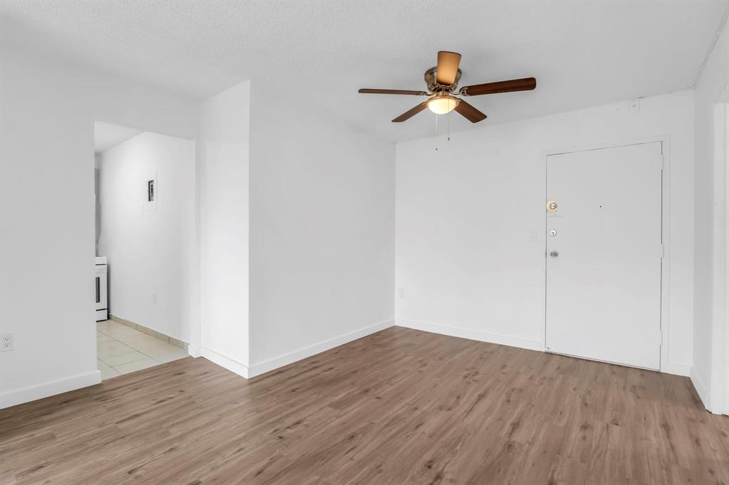 4801 Northwest 7th Street, Unit 50316 Miami, FL 33126 - Photo 5 of 31 a view of empty room with wooden floor