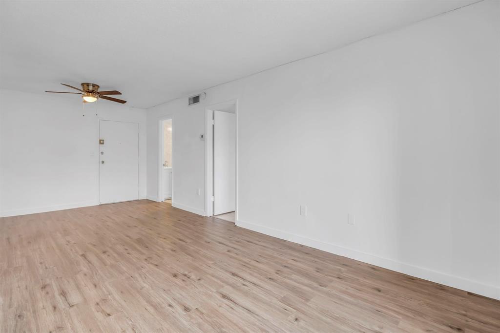 4801 Northwest 7th Street, Unit 50316 Miami, FL 33126 - Photo 6 of 31 a view of empty room with wooden floor