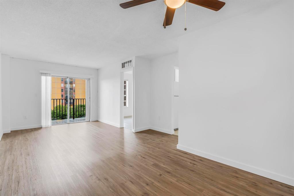 4801 Northwest 7th Street, Unit 50316 Miami, FL 33126 - Photo 9 of 31 a view of an empty room with wooden floor
