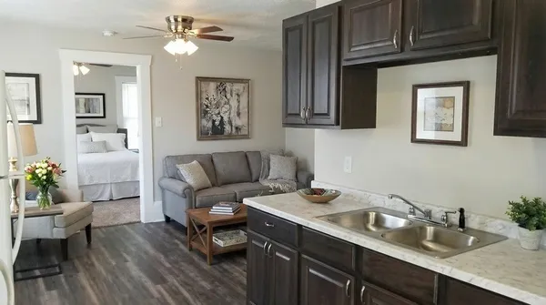 a living room with furniture and a wooden floor