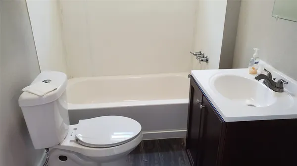a bathroom with a sink a toilet and bathtub