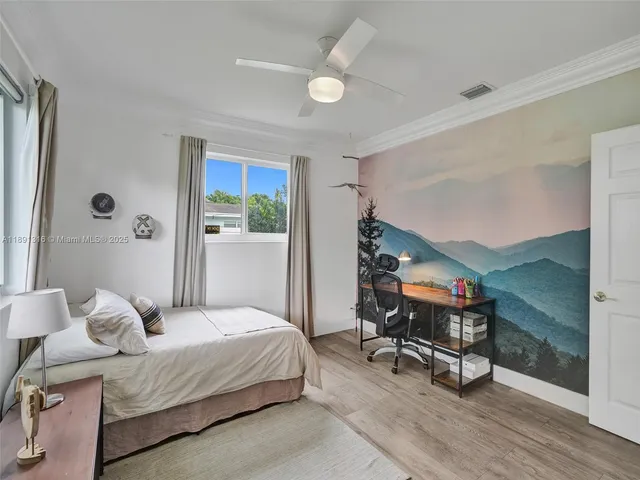 a bedroom with a bed a desk and chair