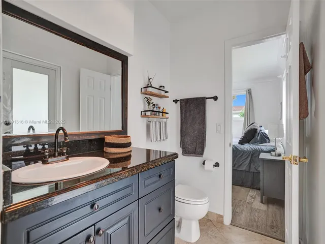 a bathroom with a granite countertop sink double vanity