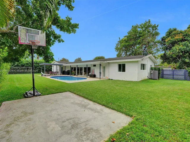 a view of a house with a yard and tree s