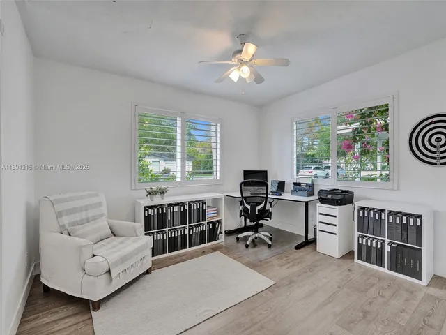 a living room with furniture a chandelier and a window