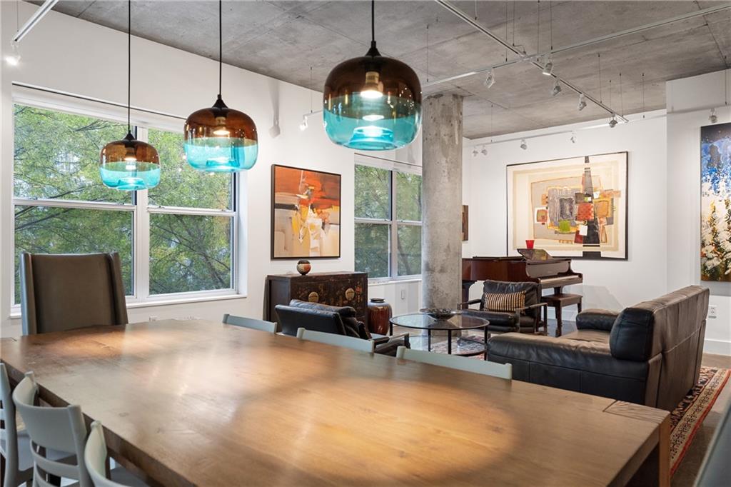 845 Spring Street Northwest, Unit 129 Atlanta, GA 30308 - Photo 12 of 48 a living room with furniture a large window and a table