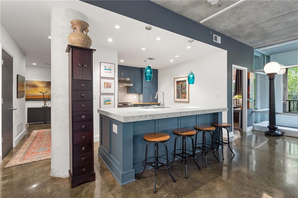 845 Spring Street Northwest, Unit 129 Atlanta, GA 30308 - Photo 15 of 48 a kitchen with stainless steel appliances granite countertop a refrigerator and a sink