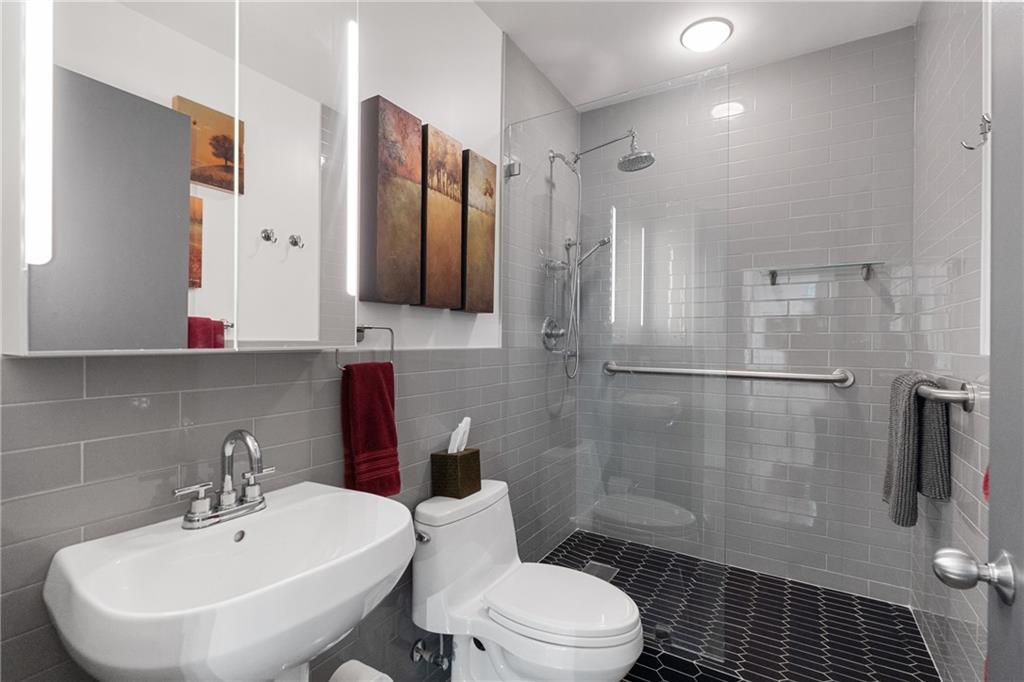 845 Spring Street Northwest, Unit 129 Atlanta, GA 30308 - Photo 21 of 48 a bathroom with a sink toilet and shower