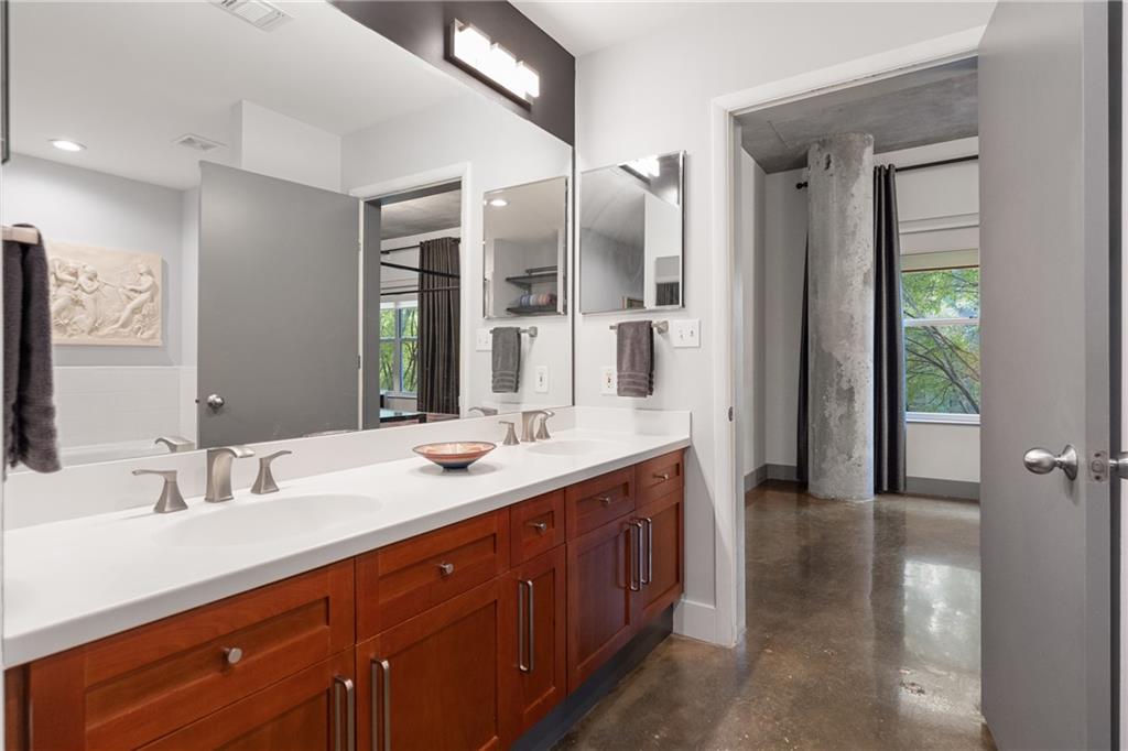 845 Spring Street Northwest, Unit 129 Atlanta, GA 30308 - Photo 29 of 48 a bathroom with a double vanity sink and a mirror