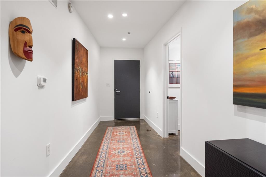 845 Spring Street Northwest, Unit 129 Atlanta, GA 30308 - Photo 4 of 48 a hallway with front door and wooden floor