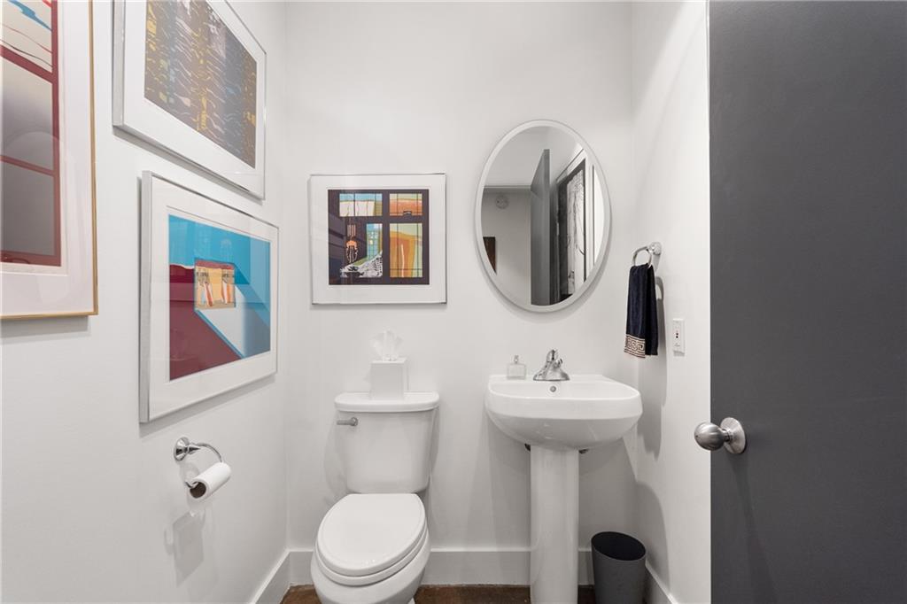 845 Spring Street Northwest, Unit 129 Atlanta, GA 30308 - Photo 7 of 48 a bathroom with a toilet sink and mirror