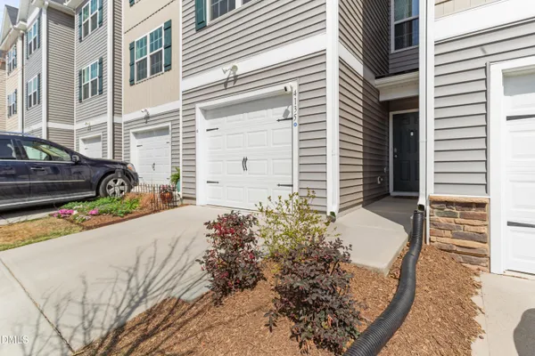 a view of room with walk in closet and wooden floor