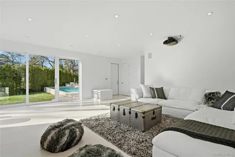 a living room with furniture and a floor to ceiling window