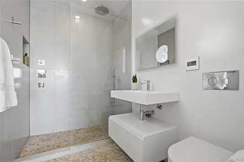 a bathroom with a toilet sink and mirror