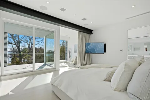 a bedroom with a large bed and a large window