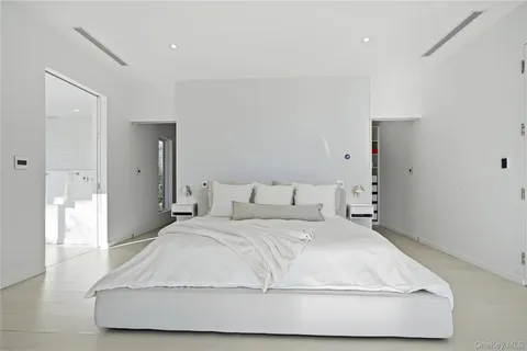 a bedroom with a bed and a night stand