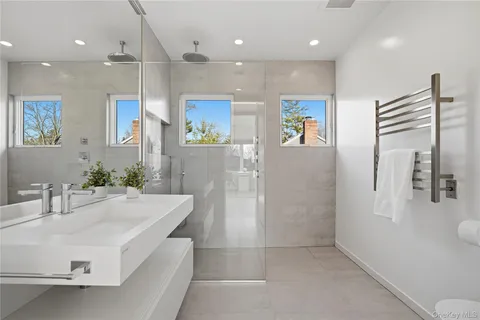 a large white kitchen with a large window