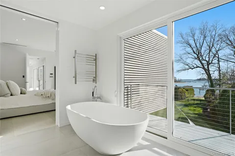 a spacious bathroom with a bathtub and next to a window