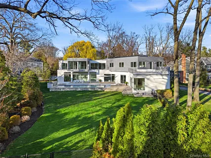 a view of house with a garden and trees