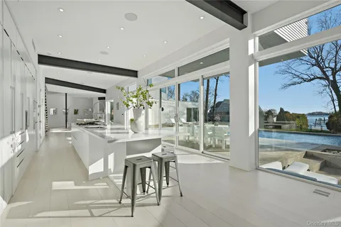 a dining hall with stainless steel appliances granite countertop a coffee table and chairs