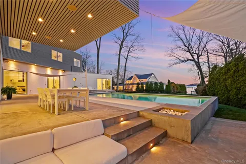 a view of swimming pool with outdoor seating and city view