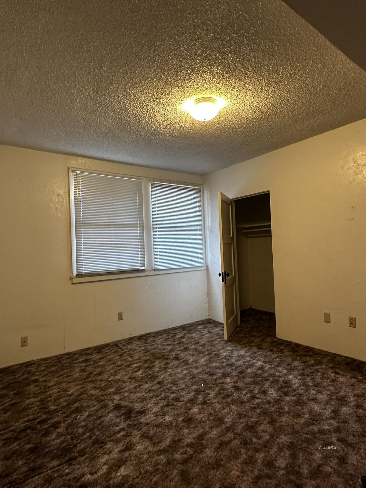 301 South Richmond Road Ridgecrest, CA 93555 - Photo 17 of 45 a view of an empty room with wooden floor and a window