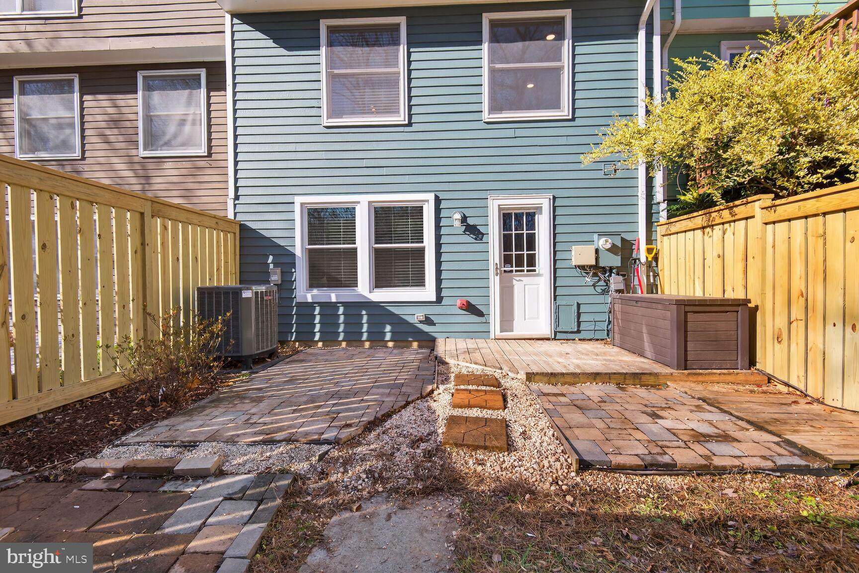 1548 Poplar Grove Drive Reston, VA 20194 - Photo 6 of 10 a view of a backyard with table and chairs and wooden fence