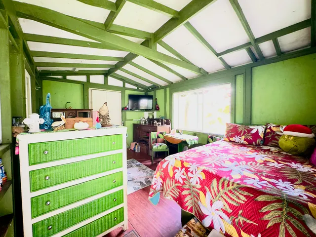 a bedroom with a bed and a mirror