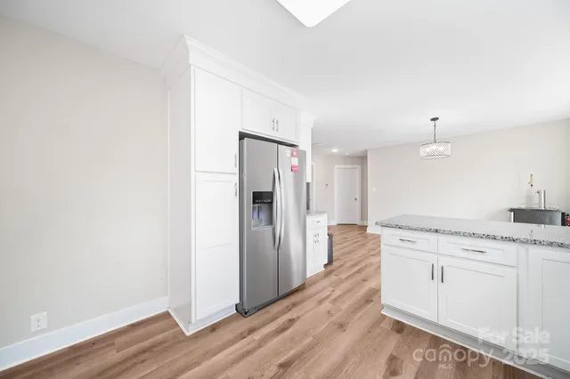 a kitchen with a refrigerator and a sink