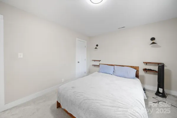 a bedroom with a bed and a chair