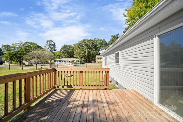 a view of balcony with wooden floor and fence