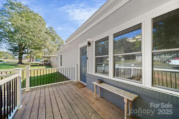 a view of a house with wooden deck