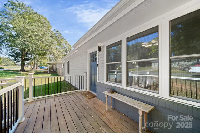a view of a house with wooden deck