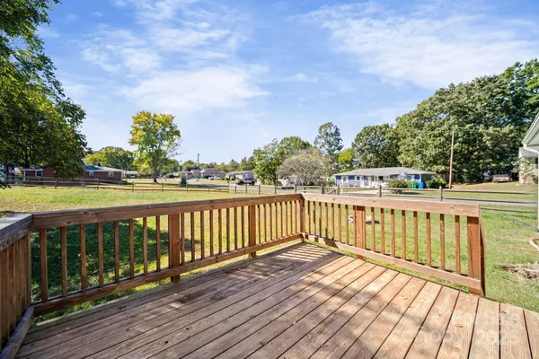 a view of wooden deck with a big yard