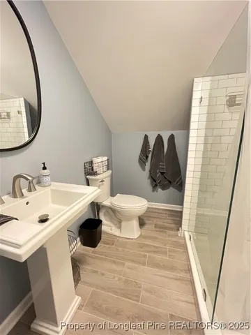 a living room with furniture a chandelier and a flat screen tv