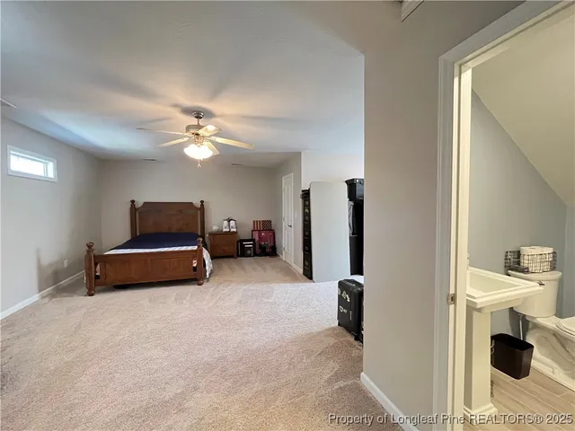 a view of staircase with lots of frames on wall and stairs