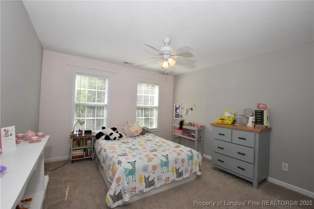 a bedroom with furniture and a flat screen tv