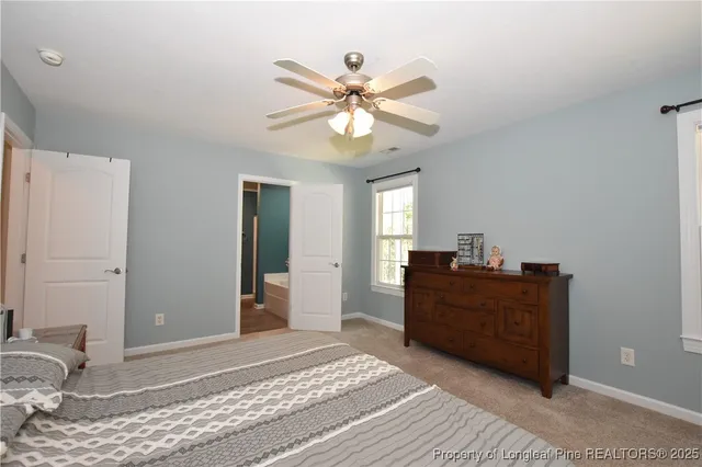 a en suite bathroom with a granite countertop sink and a mirror