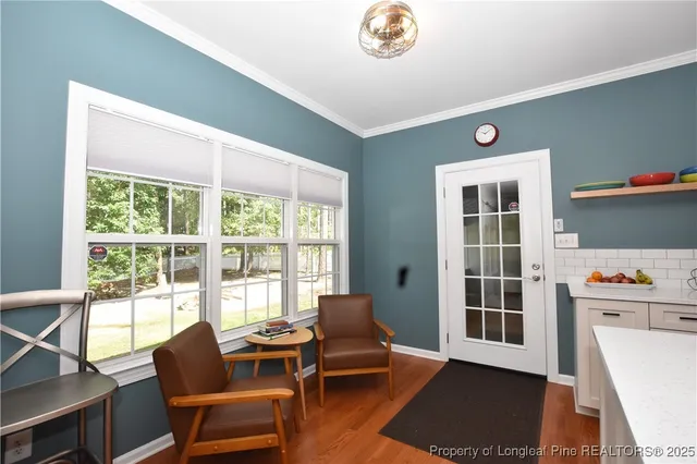 a view of a dining room with furniture window and wooden floor