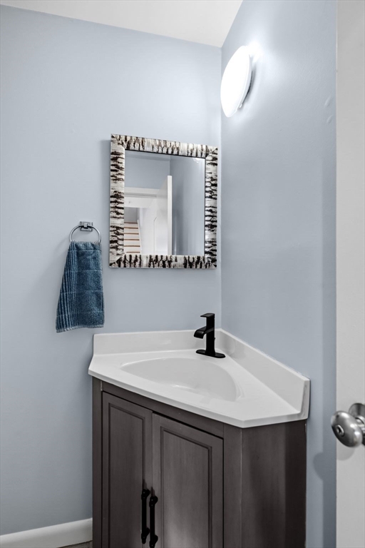 60 Brackett Place, Unit D Marblehead, MA 01945 - Photo 11 of 30 a bathroom with a sink and a mirror