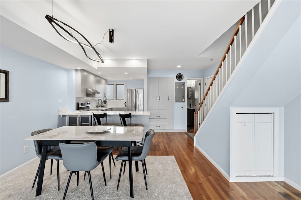 60 Brackett Place, Unit D Marblehead, MA 01945 - Photo 13 of 30 a view of a dining room with furniture and wooden floor