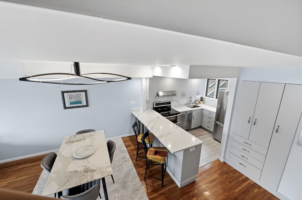 60 Brackett Place, Unit D Marblehead, MA 01945 - Photo 14 of 30 a kitchen with stainless steel appliances a stove a sink and a refrigerator