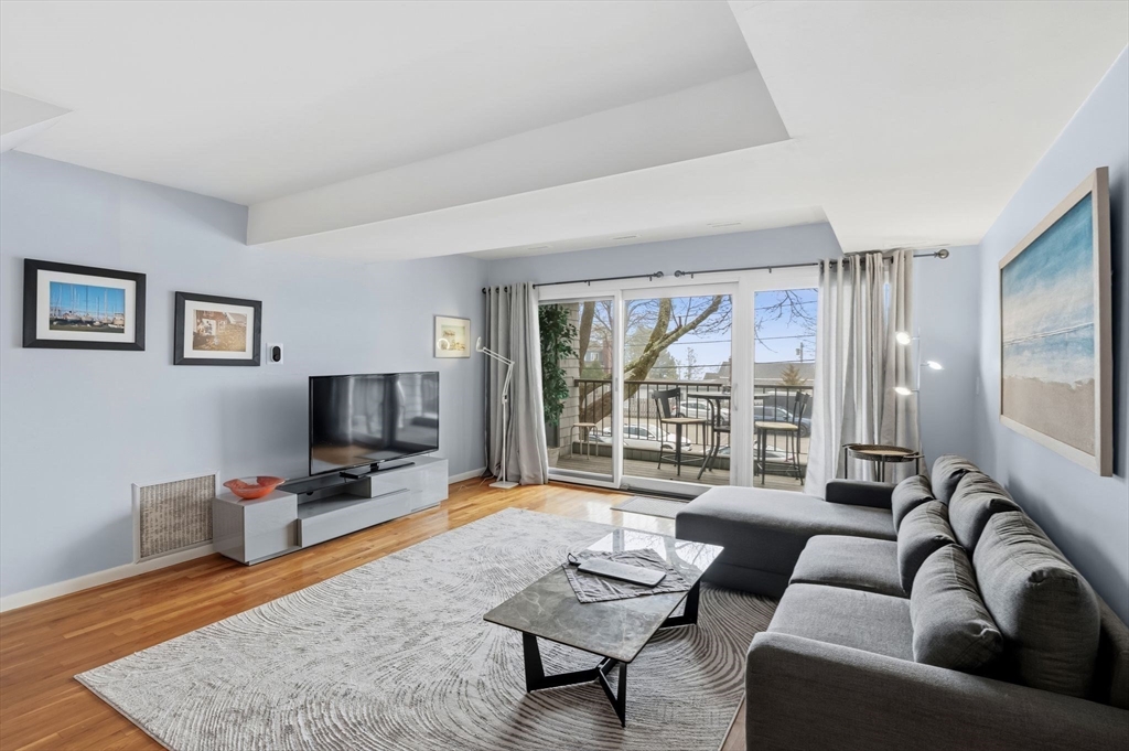 60 Brackett Place, Unit D Marblehead, MA 01945 - Photo 17 of 30 a living room with furniture and a flat screen tv