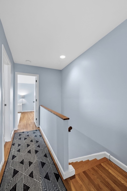 60 Brackett Place, Unit D Marblehead, MA 01945 - Photo 19 of 30 a view of a hallway with wooden floor and cabinet