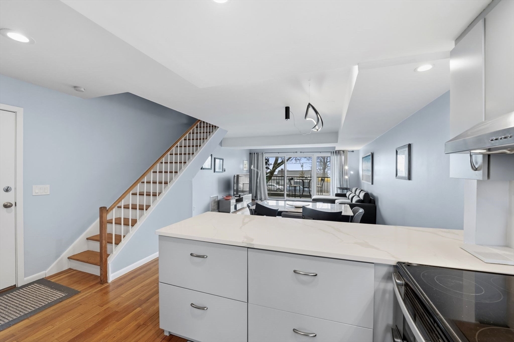 60 Brackett Place, Unit D Marblehead, MA 01945 - Photo 9 of 30 a view of a kitchen with cabinets and wooden floor