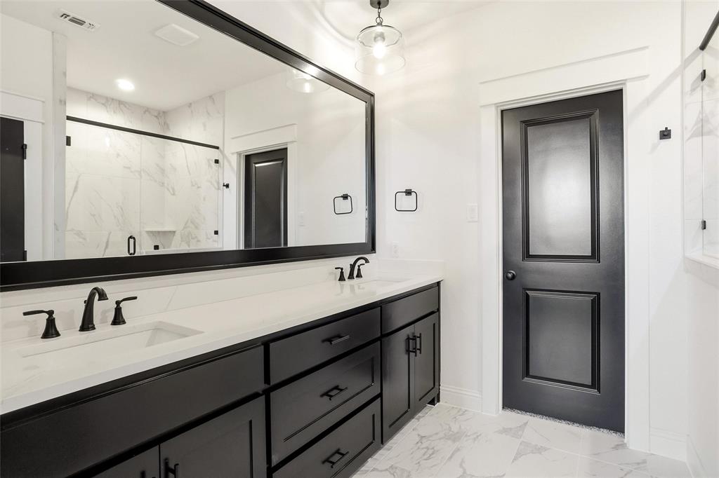 218 Legacy Boulevard Weatherford, TX 76086 - Photo 11 of 20 a bathroom with a double vanity sink and mirror