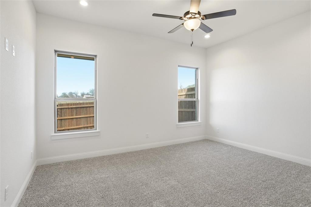 218 Legacy Boulevard Weatherford, TX 76086 - Photo 17 of 20 an empty room with a window and a fan