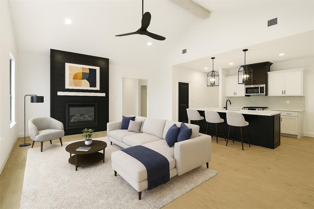 218 Legacy Boulevard Weatherford, TX 76086 - Photo 2 of 20 a living room with furniture and a fireplace